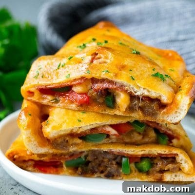 Calzone halves stuffed with sausage, peppers, cheese and pepperoni.