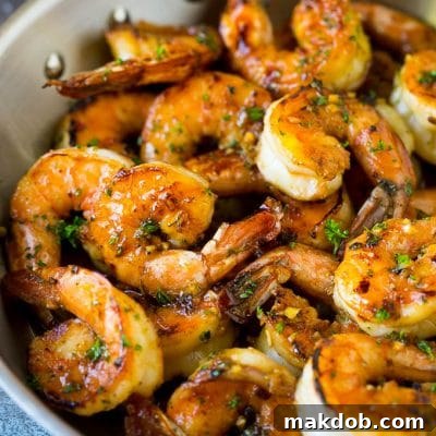 Shrimp marinade over cooked shrimp, topped with parsley.