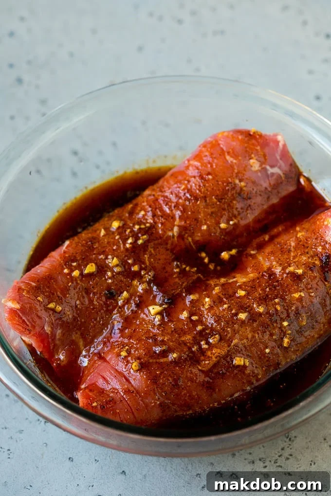 Flank steak submerged in a bright and zesty garlic and lime marinade.