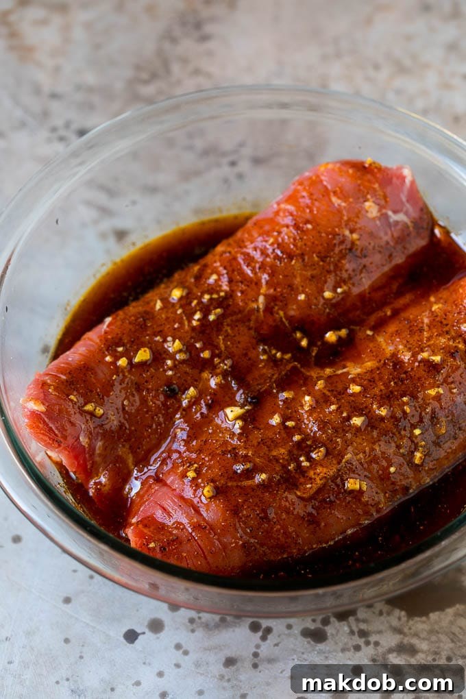 Marinated flank steak in a bowl.