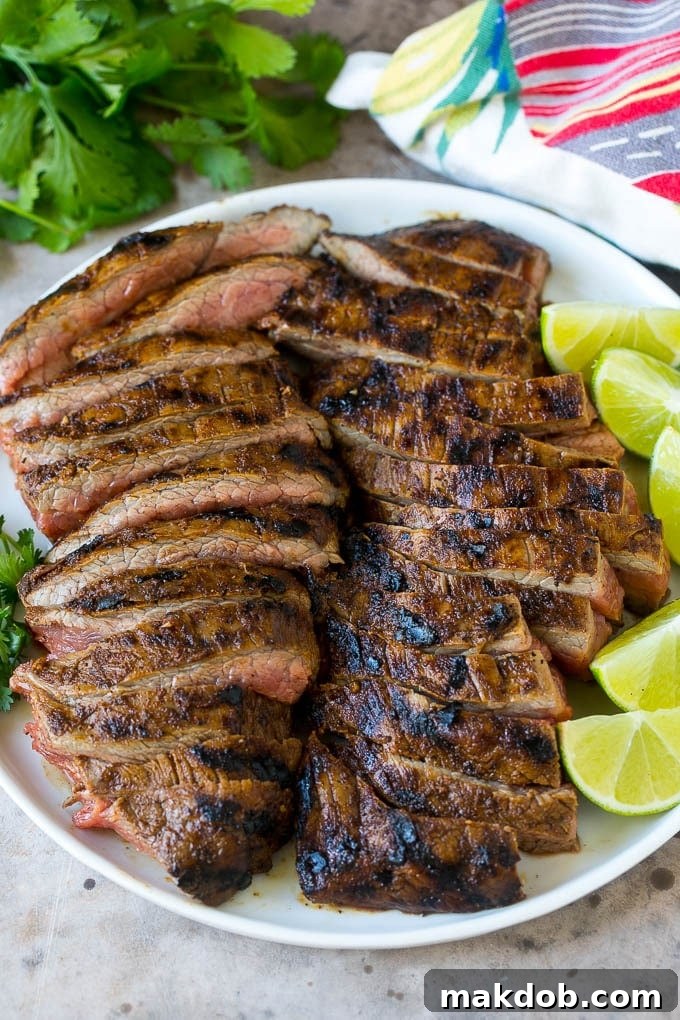 Sliced grilled flank steak on a plate.