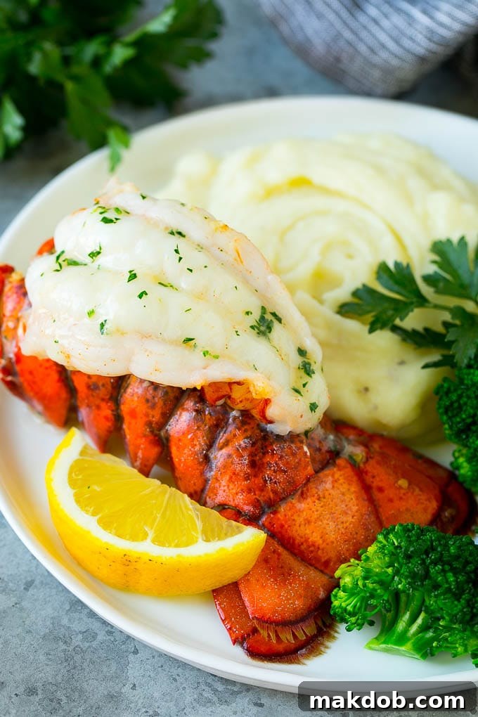 A perfectly broiled lobster tail served elegantly with creamy mashed potatoes and vibrant roasted broccoli.
