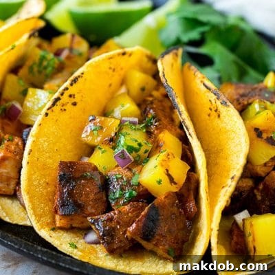 Pineapple Pork Perfection: Al Pastor Tacos 2 Tacos al pastor stuffed with grilled pork, pineapple, red onion and cilantro.