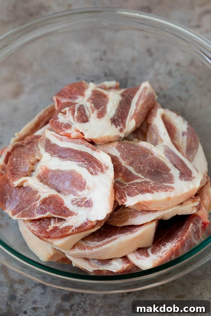 Tacos al Pastor Recipe | Pork Tacos | Mexican Tacos #tacos #pork #pineapple #grilling #tacotuesday #dinner #dinneratthezoo Sliced pork shoulder in a bowl.