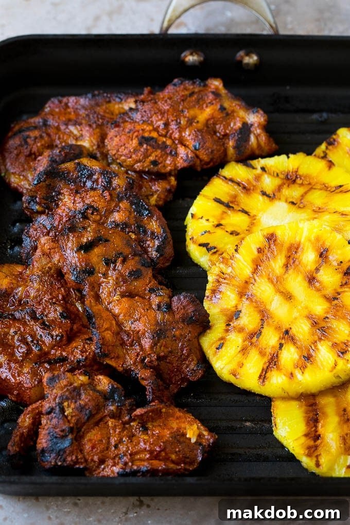 Tacos al Pastor Recipe | Pork Tacos | Mexican Tacos #tacos #pork #pineapple #grilling #tacotuesday #dinner #dinneratthezoo Grilled pork and pineapple on a pan.