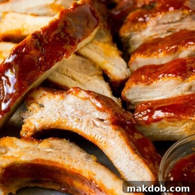 Sliced smoked ribs brushed with BBQ sauce.