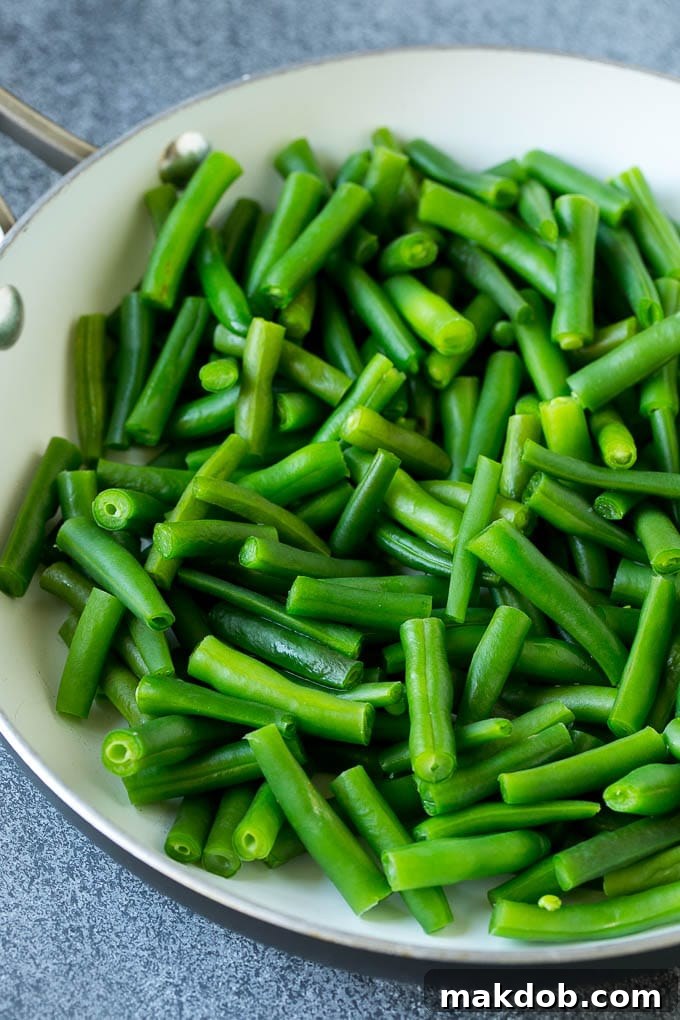 Freshly cooked green beans in a hot pan, ready for the next step of the stir fry.