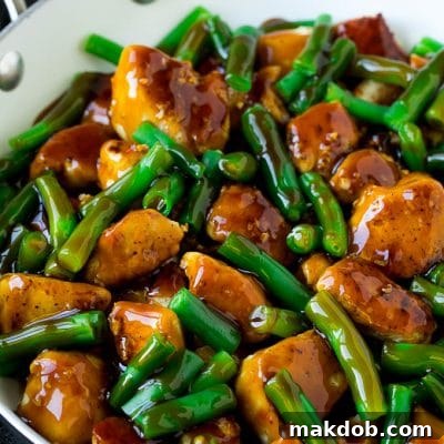 Chicken and green beans coated in honey garlic sauce, ready to be served.
