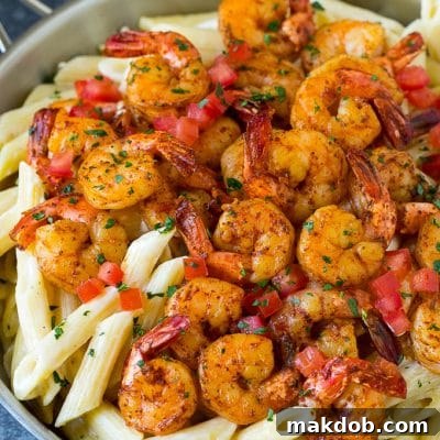 Cajun shrimp pasta with spiced shrimp, creamy sauce and tomatoes.