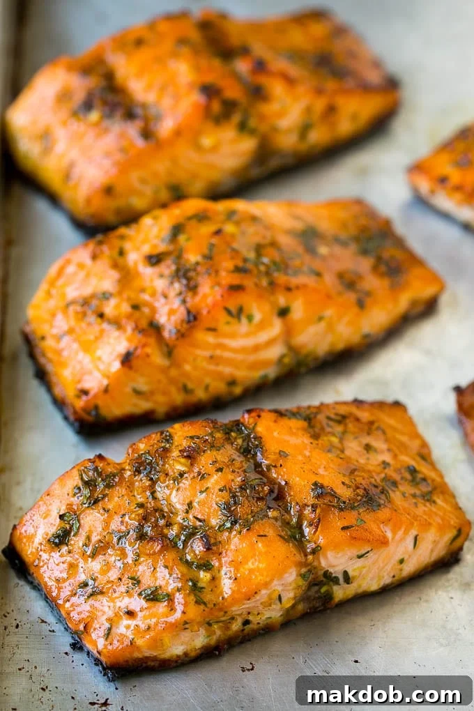 A perfectly roasted salmon fillet, golden-brown and topped with fresh garlic and herbs.