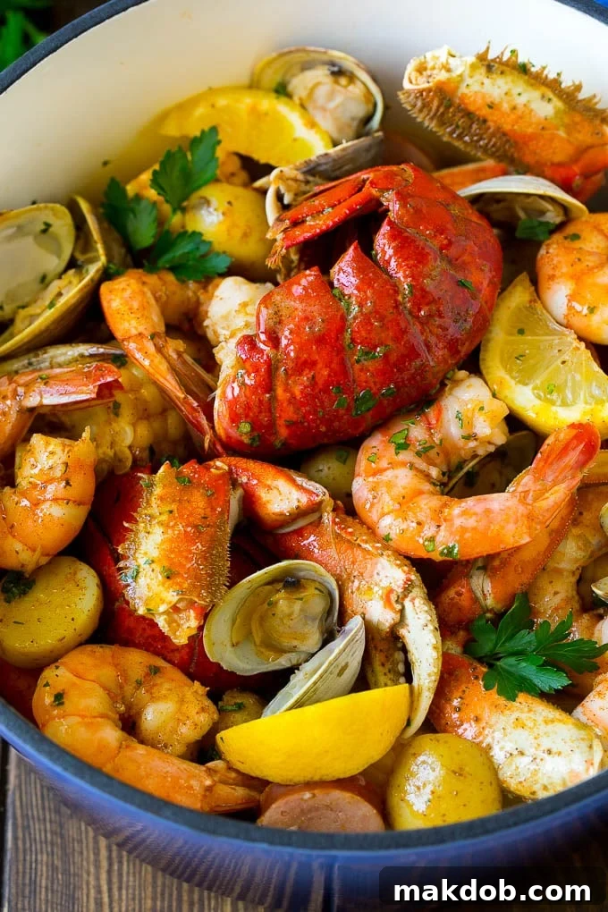 Seafood Boil Recipe | Shrimp Boil #lobster #shrimp #clams #crab #sausage #corn #potatoes #dinner #dinneratthezoo A pot of seafood boil with lobster, shrimp, corn and potatoes.
