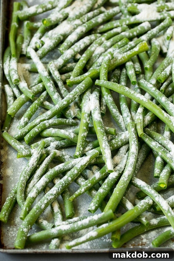 Fried Green Beans Recipe | Green Beans #greenbeans #appetizer #snack #dinneratthezoo Bean coated in flour on a pan.
