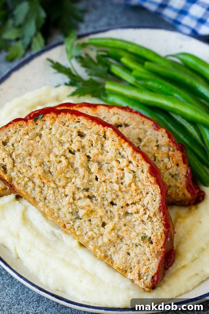 Simple Weeknight Turkey Meatloaf 4 Sliced turkey meatloaf served over mashed potatoes with green beans.