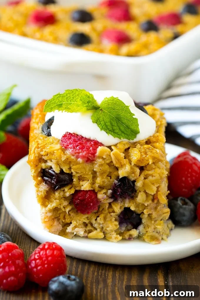 Baked Oatmeal Recipe | Meal Prep | Healthy Oatmeal #oatmeal #casserole #breakfast #brunch #dinneratthezoo #mealprep A serving of baked oatmeal topped with yogurt and served with fresh berries.