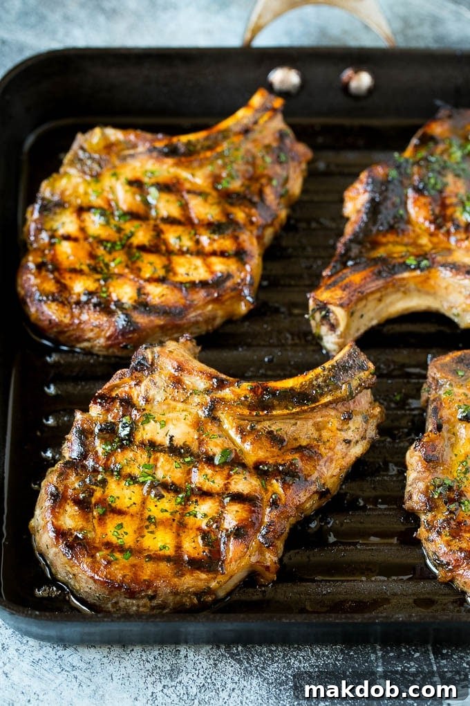 Pork Chops on Grill Pan Sizzling marinated pork chops cooking on a hot grill pan, showcasing perfect sear marks.
