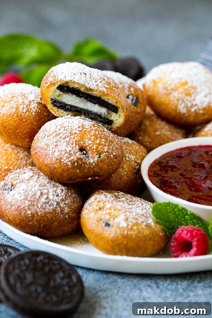 A plate of fried Oreos with one cut open, revealing the melted filling.