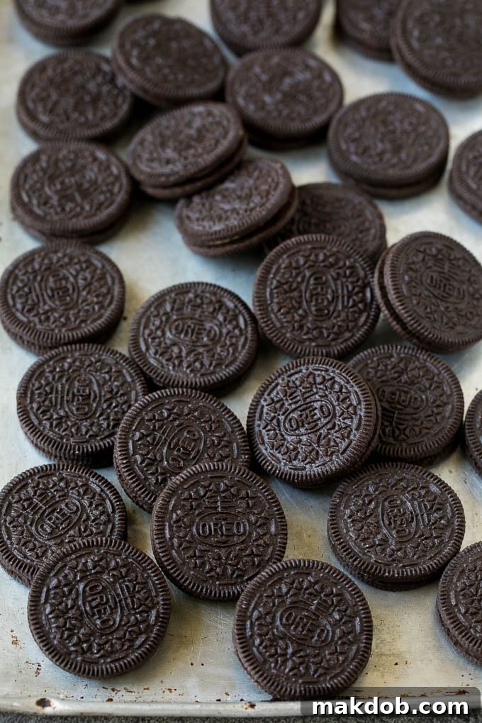 Oreos on a sheet pan, ready for dipping.