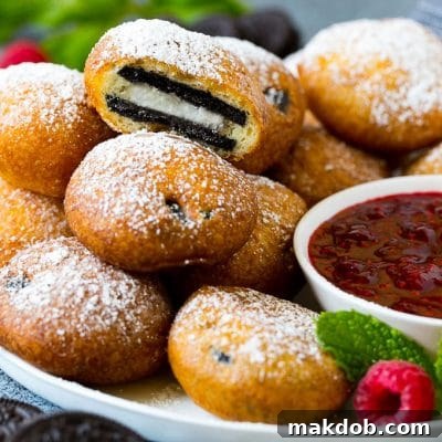 A plate of fried Oreos with one cut open.