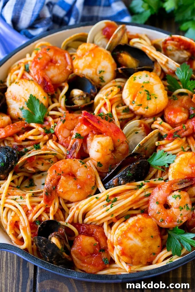 A skillet of seafood pasta with spaghetti, shrimp and shellfish.