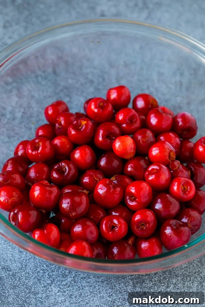 Cherry Pie Filling Recipe #pie #cherries #dessert #sweets #dinneratthezoo #summer A bowl filled with perfectly pitted fresh cherries, ready for cooking.