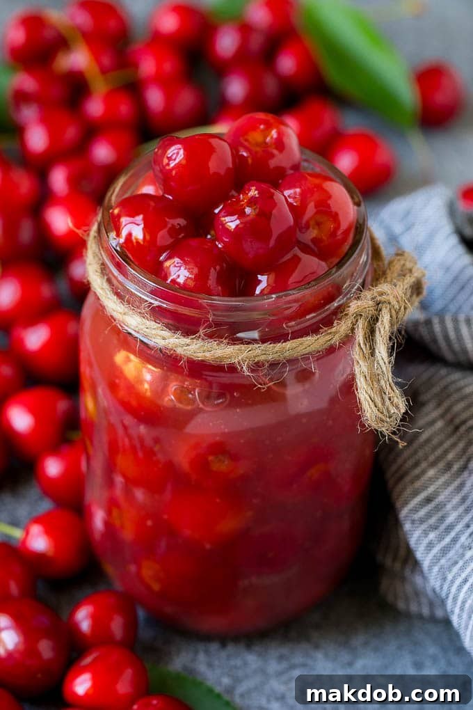 Cherry Pie Filling Recipe #pie #cherries #dessert #sweets #dinneratthezoo #summer Homemade cherry pie filling beautifully presented in a clear mason jar.