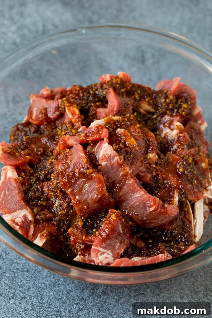 Beef Bulgogi Recipe | Korean BBQ #beef #koreanfood #grilling #steak #dinner #dinneratthezoo Strips of rib eye in a bowl of marinade.
