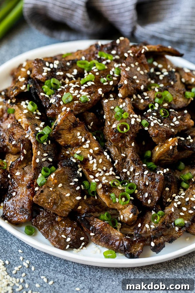 Beef Bulgogi Recipe | Korean BBQ #beef #koreanfood #grilling #steak #dinner #dinneratthezoo A plate of grilled beef bulgogi topped with sesame seeds and green onions.