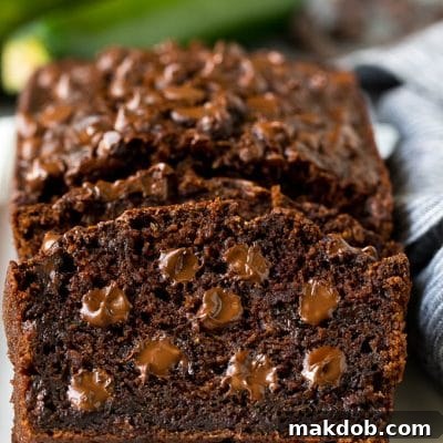 Sliced chocolate zucchini bread filled with melted chocolate.
