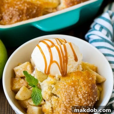 Apple cobbler served with vanilla ice cream and caramel sauce.