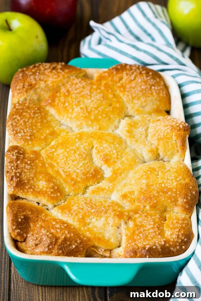 Apple Cobbler Recipe | Apple Dessert #apples #cobbler #dessert #baking #fall #dinneratthezoo A dish of baked apple dessert topped with sugar.