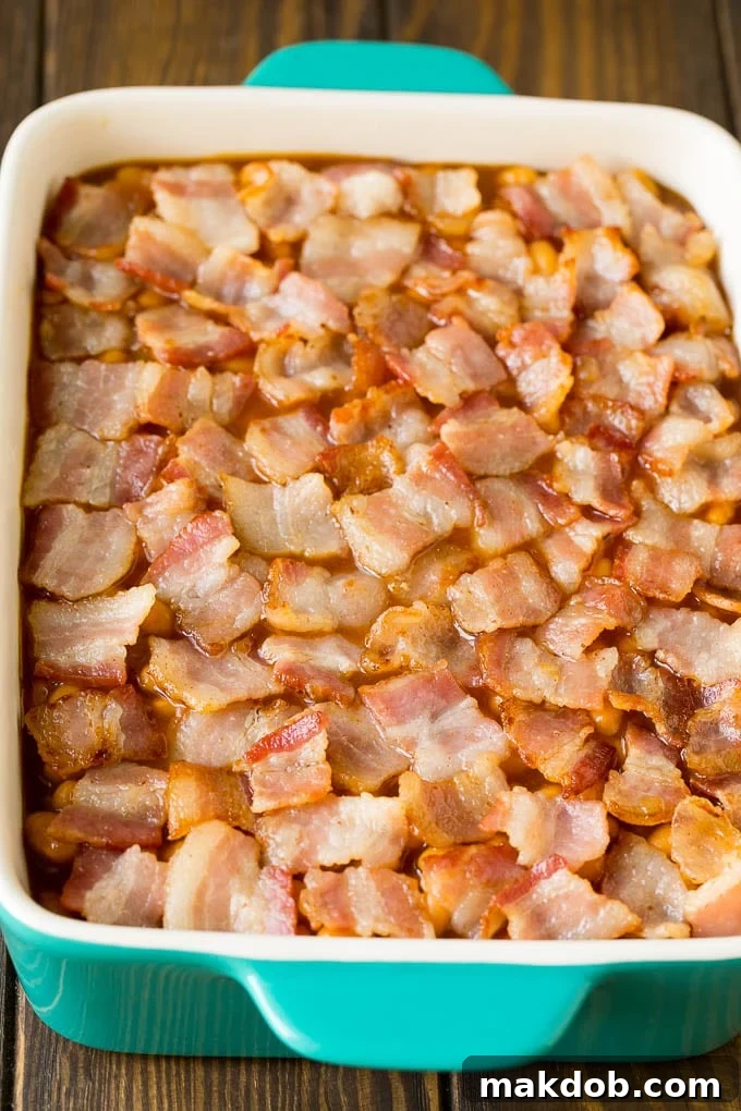 Smoky Bacon Baked Beans 5 A baking dish of beans topped with chopped bacon.