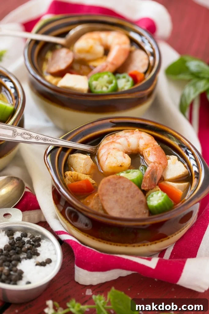 Single Skillet Surf & Turf Gumbo 7 A child's hand reaching for a bowl of One Pot Chicken and Shrimp Gumbo, indicating its family-friendly and quick nature for a 30-minute meal.