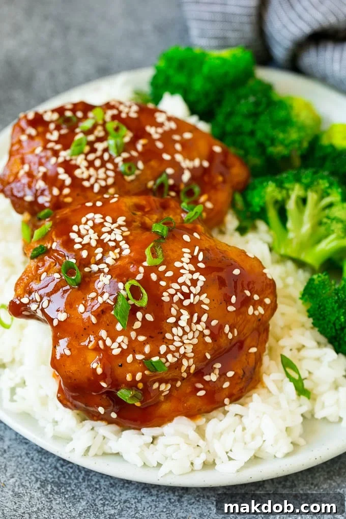 A perfectly balanced meal featuring slow cooker chicken thighs served alongside fluffy white rice and bright green steamed broccoli.