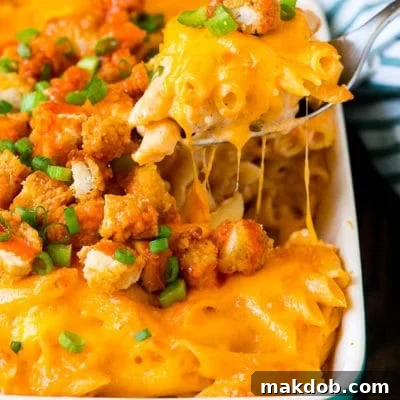 A spoon serving up a portion of buffalo chicken pasta.