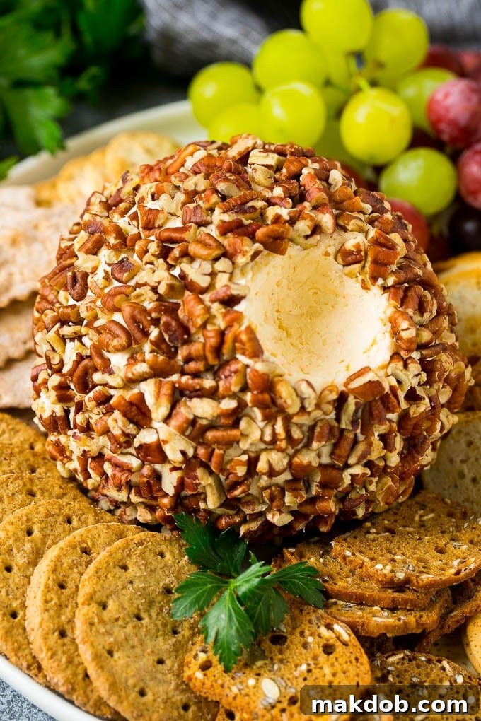 Irresistible Cheese Ball Appetizer 2 A cheese ball with a serving scooped out.
