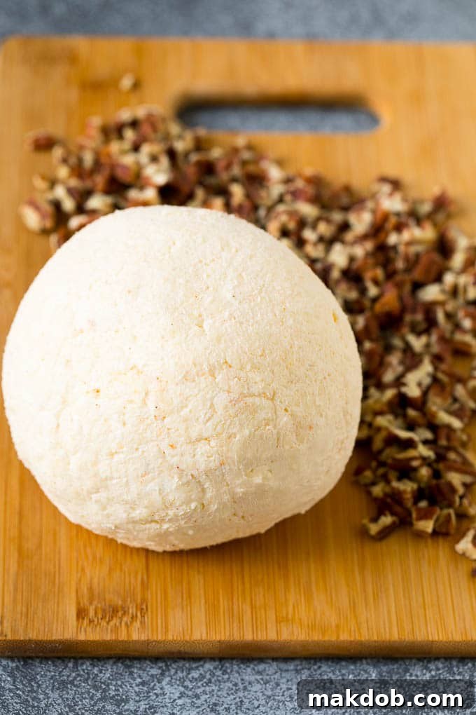 Irresistible Cheese Ball Appetizer 4 A ball of cream cheese and cheddar cheese.