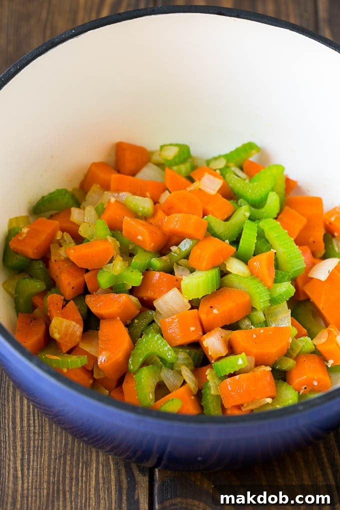Chicken Stew Recipe | Chicken and Vegetable Soup #stew #soup #chicken #potatoes #comfortfood #dinner #dinneratthezoo Onions, carrots, celery and garlic in a pot.