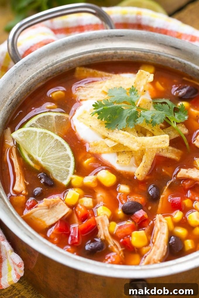 A large pot of rich and hearty chicken taco soup, ready to be served, promises a quick and satisfying meal in just 25 minutes.