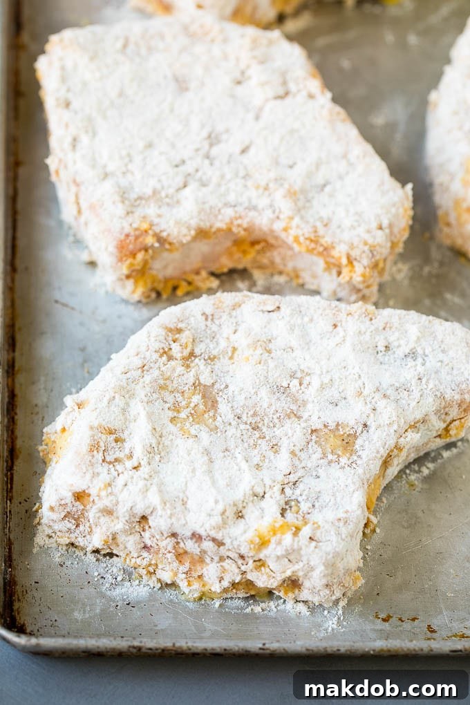 Pork chops dredged in flour and eggs.