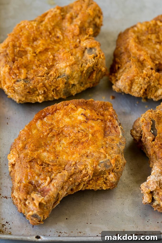 Crispy pork chops on a sheet pan.