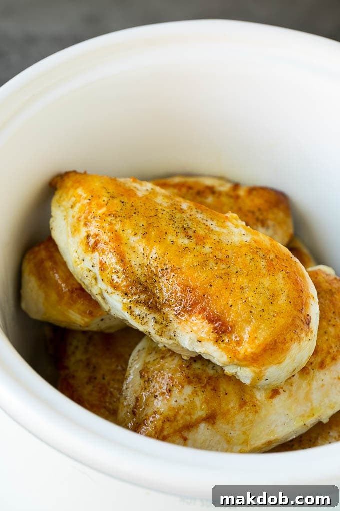 Slow Cooker Chicken Breast Recipe | Crock Pot Chicken Breast | Chicken and Gravy Seared chicken breasts in a crock pot, prior to slow cooking.