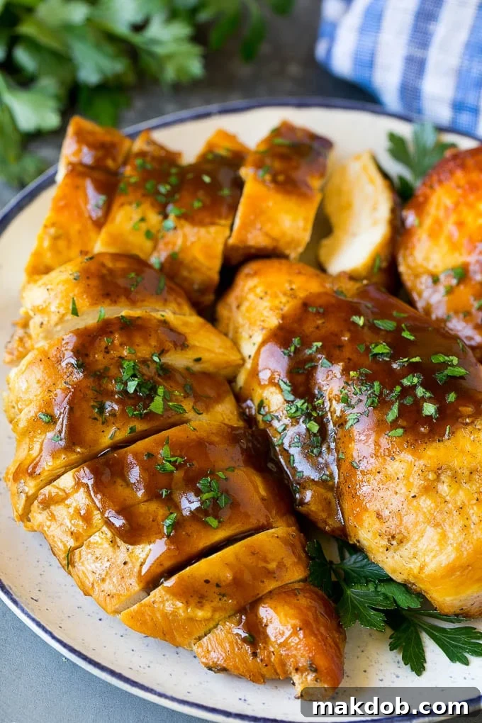 Slow Cooker Chicken Breast Recipe | Crock Pot Chicken Breast | Chicken and Gravy Sliced crock pot chicken breasts on a serving plate, ready to be enjoyed.