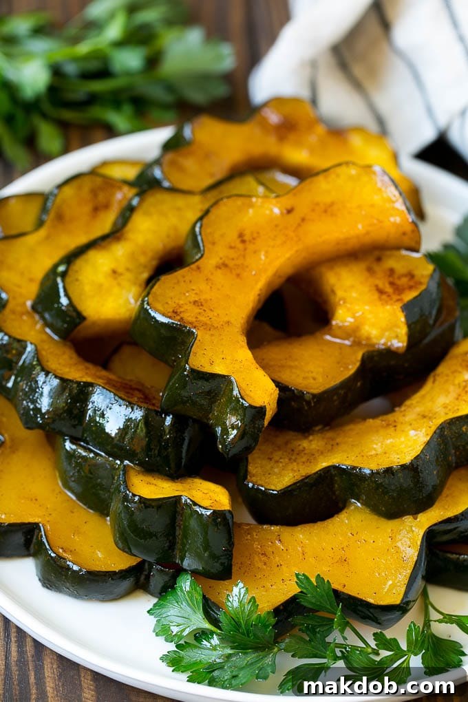 A beautifully arranged serving plate of roasted acorn squash, garnished and ready.