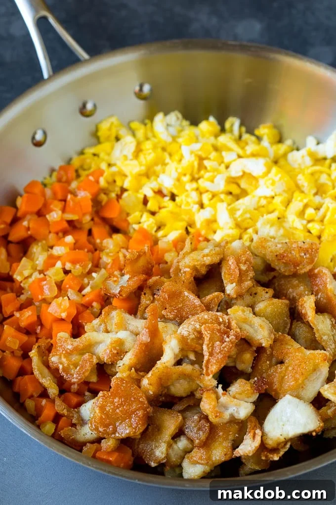 Thinly sliced cooked chicken with carrots and scrambled eggs.