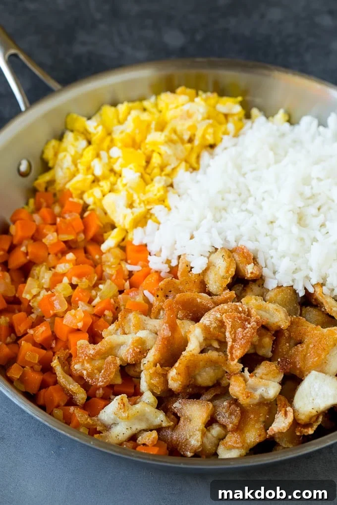 Cooked white rice with thinly sliced chicken, eggs and vegetables.