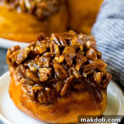 Ultimate Sticky Buns 2 Sticky buns topped with caramel and pecans.