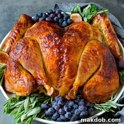 Perfect Spatchcock Turkey 2 Spatchcock turkey garnished with grapes and fresh herbs.