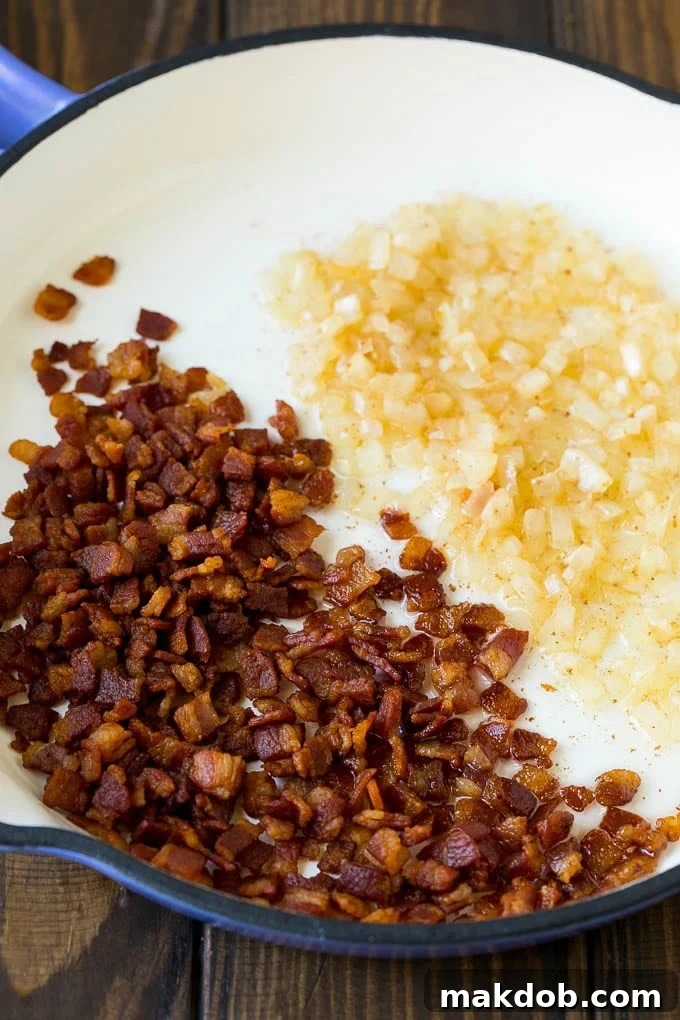 Crispy cooked bacon and fragrant sautéed onions in a skillet, building the flavor base.