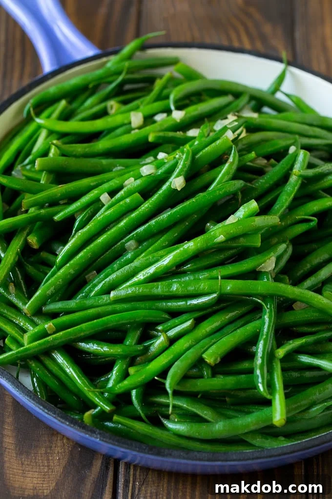 Perfectly cooked green beans tossed with aromatic diced onion, capturing the essence of the dish.