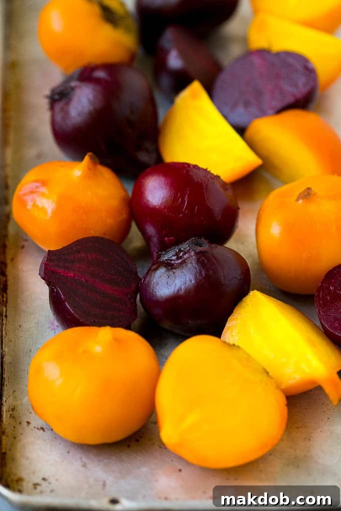 Roasted red and yellow beets on a sheet pan.